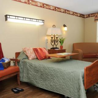A cozy living room featuring a sofa bed, warm lighting, and comfortable seating.