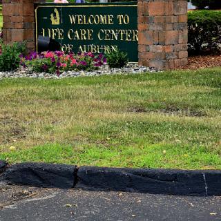 Welcome sign at the Life Care Center in Auburn, surrounded by landscaping.