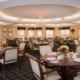 An elegant dining room with decorated tables and a chandelier.