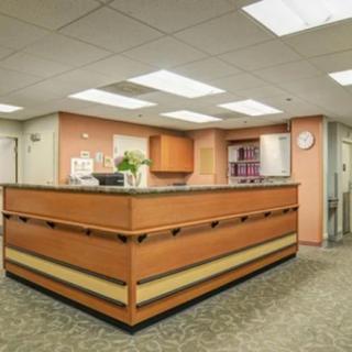 A reception desk area with warm lighting and a welcoming atmosphere.