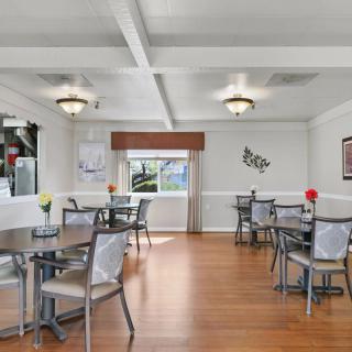 A well-lit dining area with modern decor and wooden flooring.