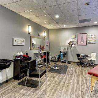 A modern salon interior featuring hair styling chairs, mirrors, and professional equipment.