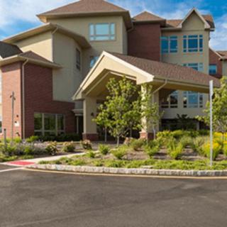 A modern residential building with landscaped surroundings.
