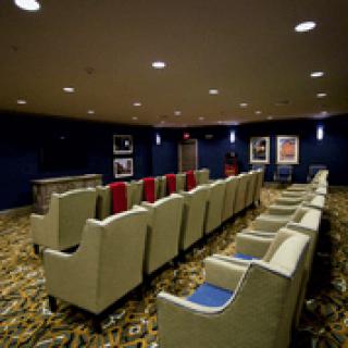 A cozy home theater with comfortable seating and a carpeted floor.