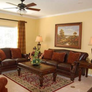 A cozy living room with a sofa set, decorative lamps, and a central coffee table.