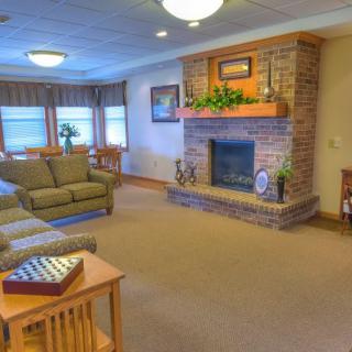 A cozy living room with a brick fireplace and comfortable seating.