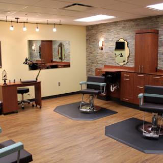 A modern hair salon equipped with stylish chairs and a warm ambiance.