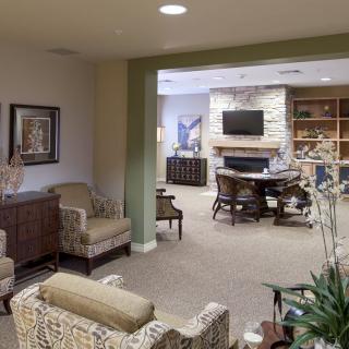 A cozy living room featuring comfortable seating, a fireplace, and a television.