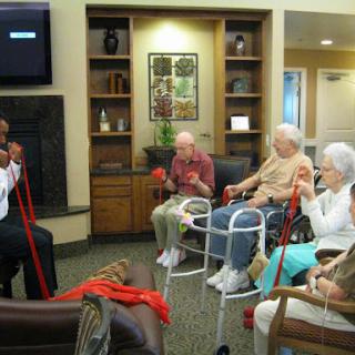A session focused on physical activity conducted for a group of seniors in a community center.