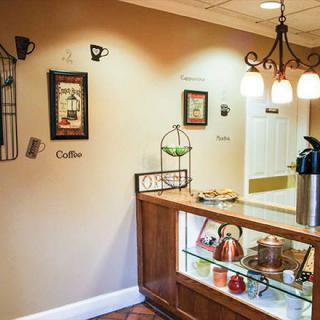A cozy coffee station with decorative elements and warm lighting.