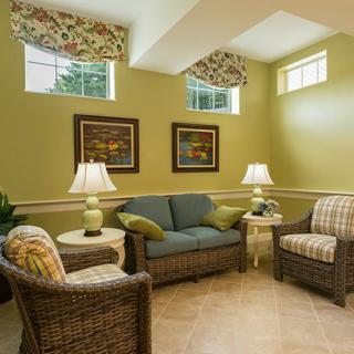 A cozy living room with wicker furniture and warm lighting.