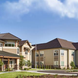 A modern residential apartment complex under a clear blue sky.