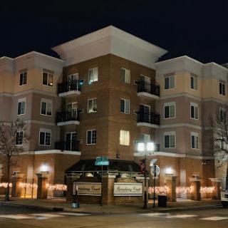 A modern residential building illuminated at night.