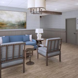 A modern living room with blue and gray decor, featuring a comfortable sofa set, chairs, a side table, and a large piece of abstract artwork on the wall.