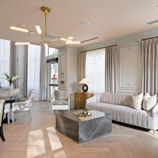 A stylish and modern living room with a blend of elegant decor and contemporary furnishings.
