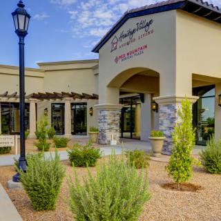 Exterior view of a restaurant with landscaped surroundings on a sunny day.