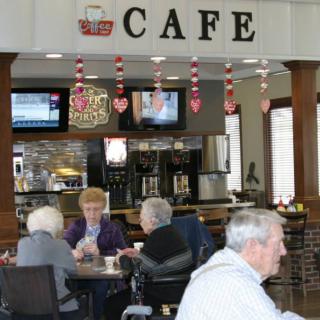 Seniors enjoying a gathering at a cozy cafe.