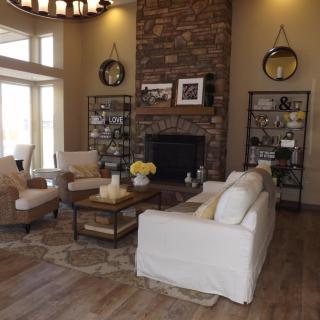 A cozy living room with a fireplace, comfortable seating, and elegant decor.