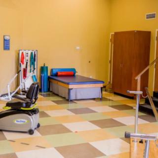 An indoor gym with various exercise equipment and workout space.