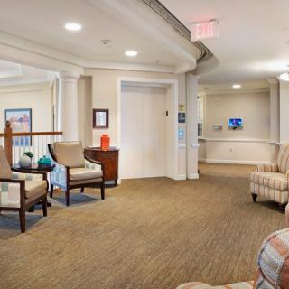 A comfortable lobby area with chairs and an elevator.
