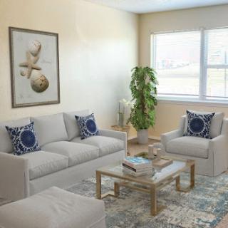 A modern and inviting living room featuring a comfortable seating arrangement, stylish decor, and ample natural light.