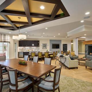 A modern open-concept dining and living area with stylish furnishings and a well-lit interior.