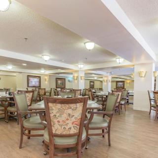 A spacious and well-lit dining area with elegant chairs and tables.