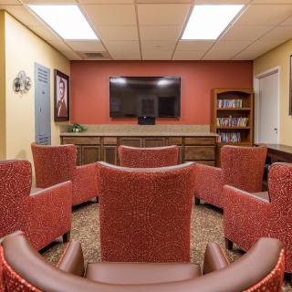 A cozy seating area with a television and bookshelves.