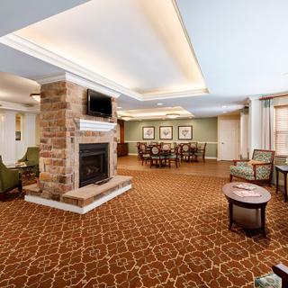 A cozy living room with a stone fireplace and comfortable seating.