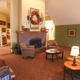 A cozy living room with a brick fireplace and comfortable seating.