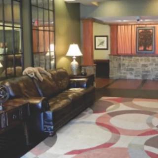 A cozy hotel lobby with a leather sofa and warm lighting.