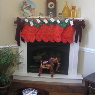 A festive fireplace decorated with red Christmas stockings hanging from the mantel.