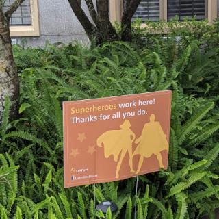 A sign expressing gratitude, placed among lush greenery.