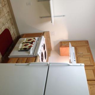 A small kitchen with appliances and wooden cabinets.