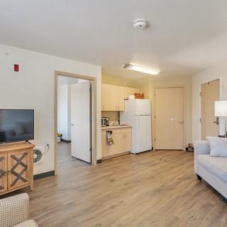 A modern apartment interior featuring a cozy living room and kitchen area.