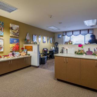 A well-decorated office space featuring artwork and tidy furnishings.