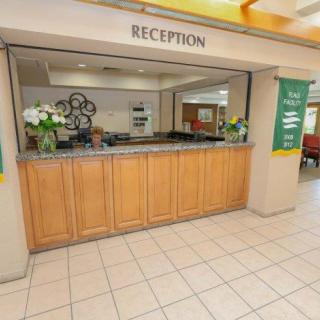 A welcoming hotel reception desk with floral decorations.