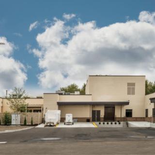 A modern building set against a cloudy sky.