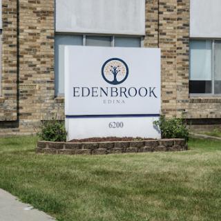 Sign for Edenbrook displayed in front of a brick building.