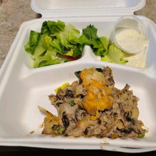Takeout meal with salad and a cheesy entre.