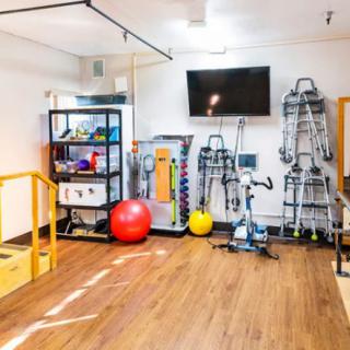 A well-equipped workout and rehabilitation space with various fitness equipment.