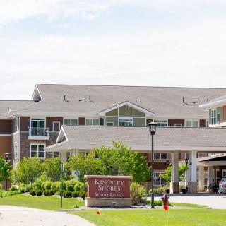 A retirement community building with a landscaped entrance.