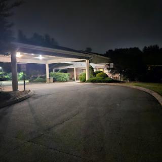 A quiet parking area illuminated under the night sky.