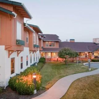 A picturesque hotel exterior with a landscaped courtyard and winding pathway.