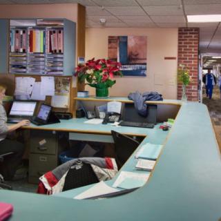A reception area with computers and paperwork in a medical or office environment.