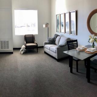 A minimalist living room with a sofa, table, and chair.