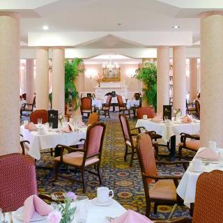 An elegant restaurant dining area with neatly arranged tables and chairs.