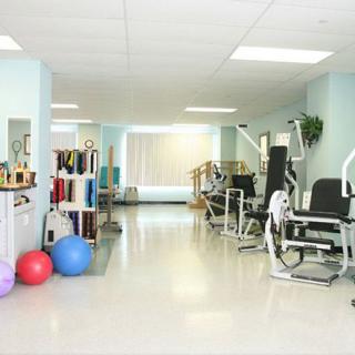 A spacious gym area equipped with exercise machines and fitness accessories.