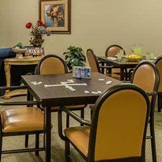 A cozy dining area with tables and chairs, set up for a game.