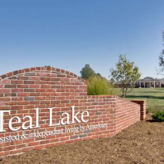 A brick sign marking the entrance to Teal Lake residential area.